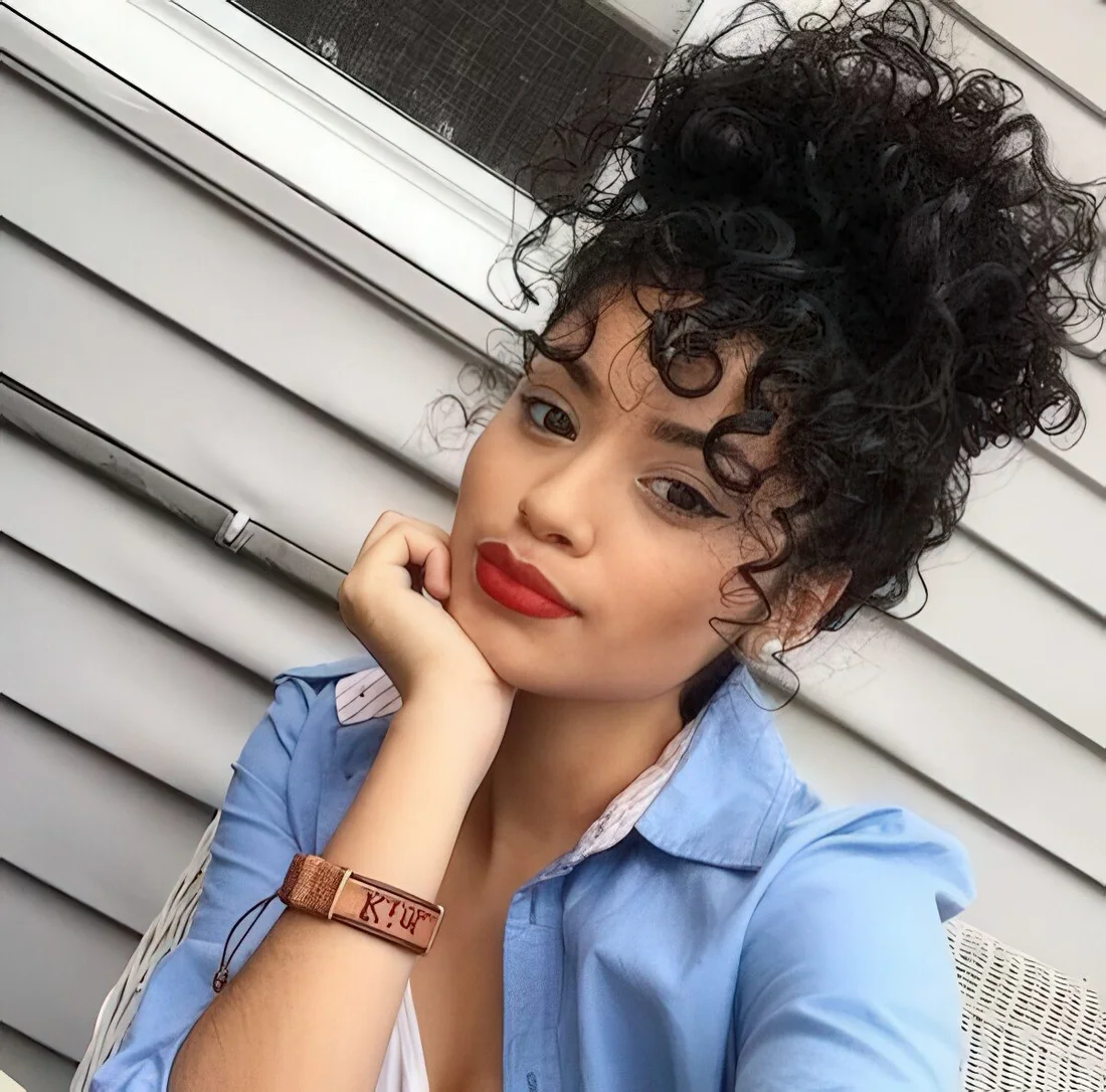 Photo showing curly bun with some curls down, with the hairstyle clearly visible.
