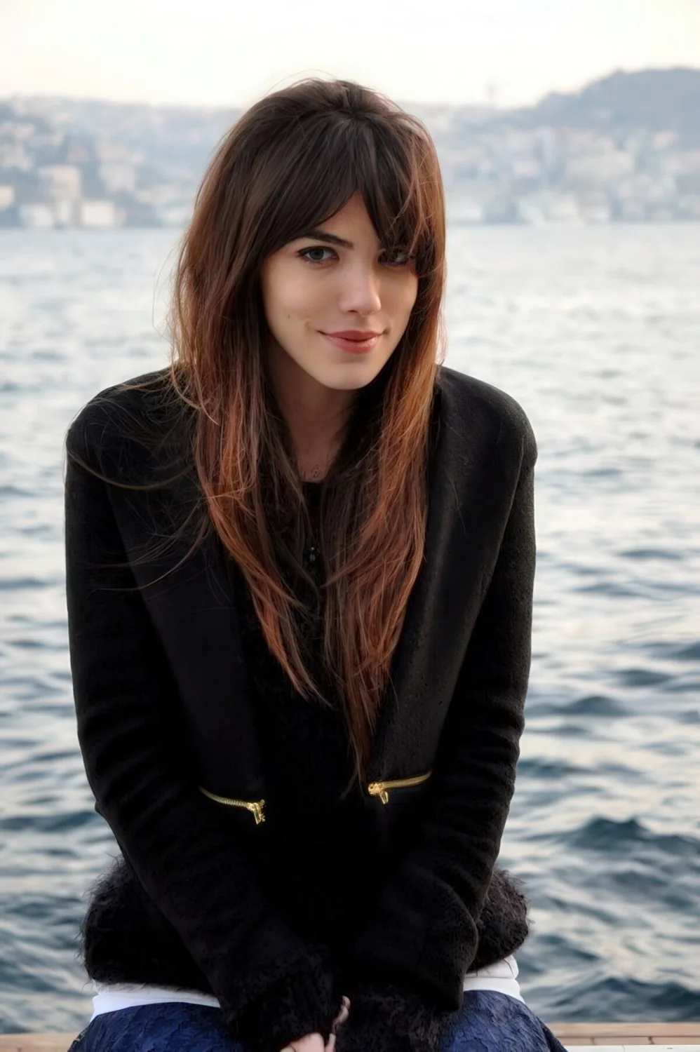 Long textural haircut with shaggy bangs and cascades for an effortlessly chic look.