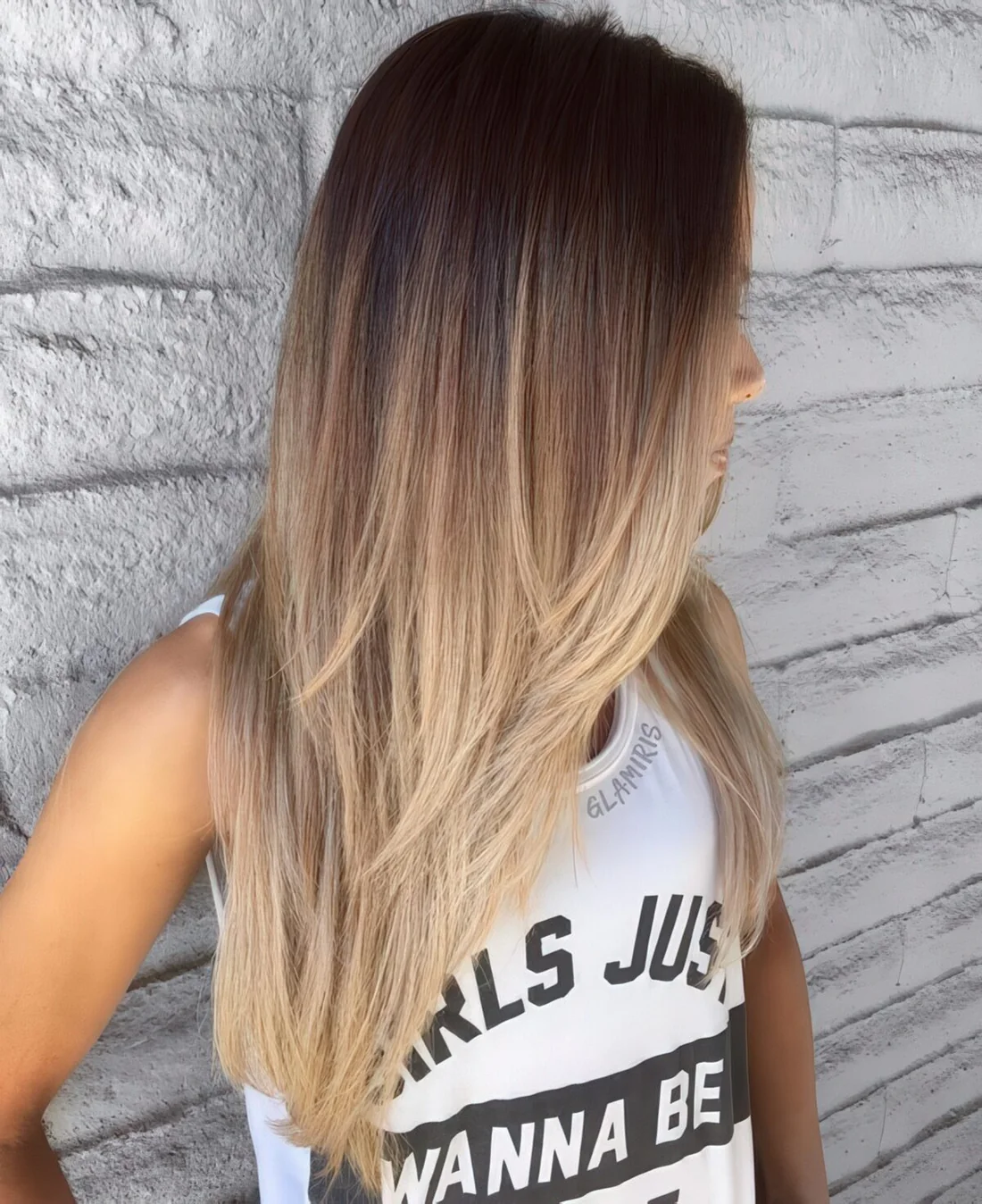Long cascading layered haircut with a brown to blonde ombre to make a statement.