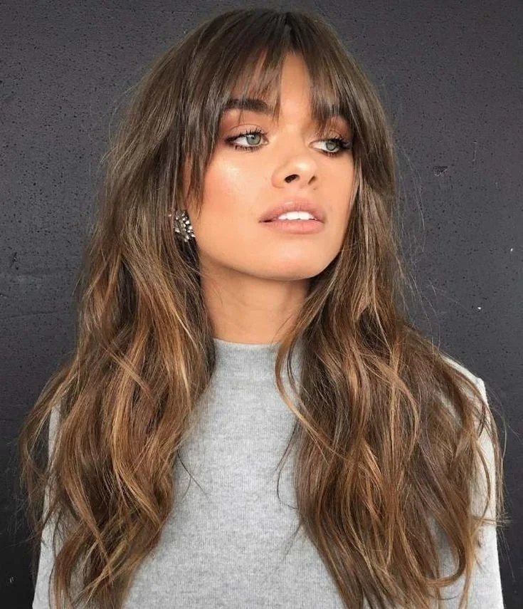 Photo showing wavy shaggy haircut, with the hairstyle clearly visible.