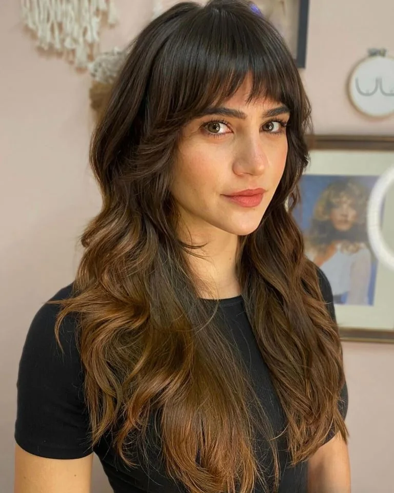 Photo showing layered waves and bangs, with the hairstyle clearly visible.