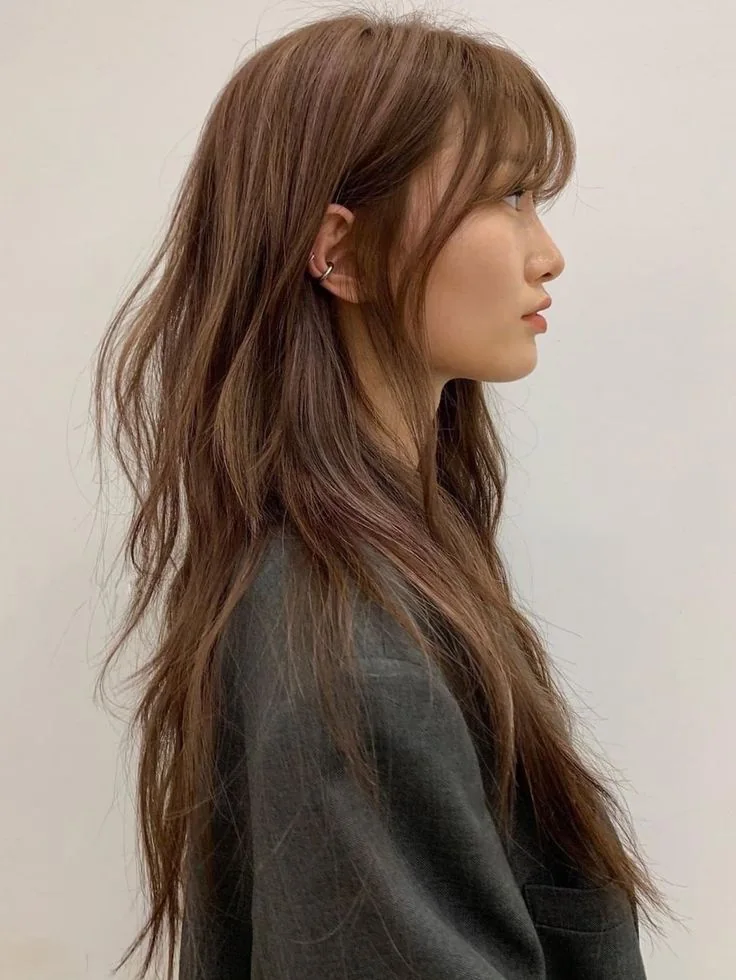 Photo showing long brown shag, with the hairstyle clearly visible.