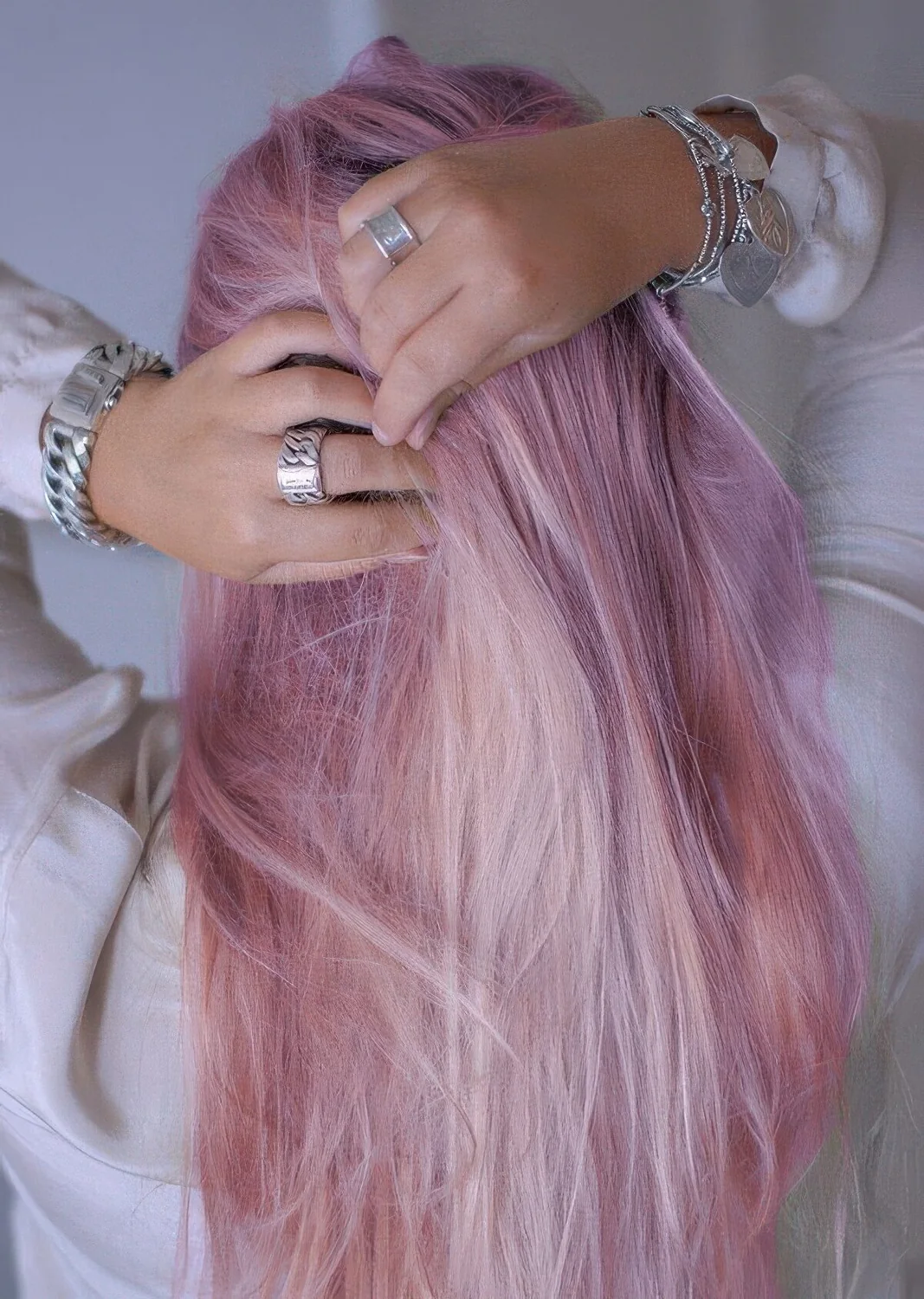 Long lilac and peachy pink hair with texture and volume.