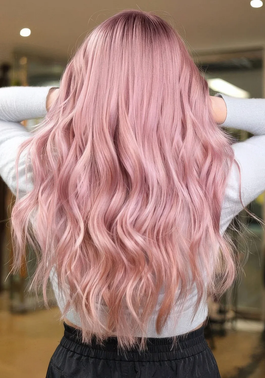 Pastel pink long hair with a lot of volume and waves.