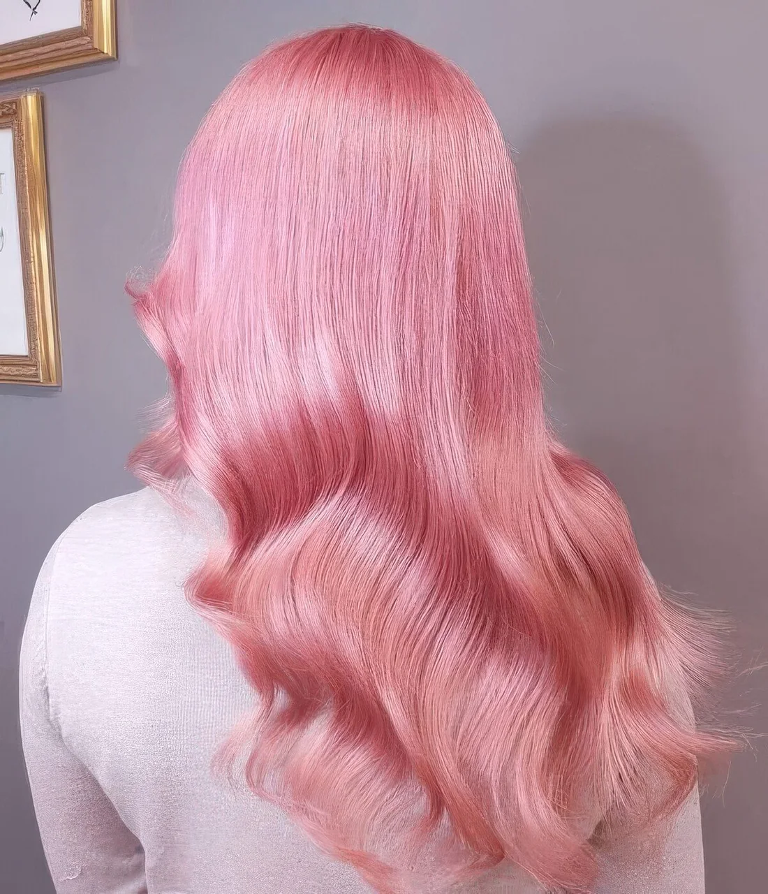 Fab bubblegum pink hair with a shiny finish and some waves and volume.