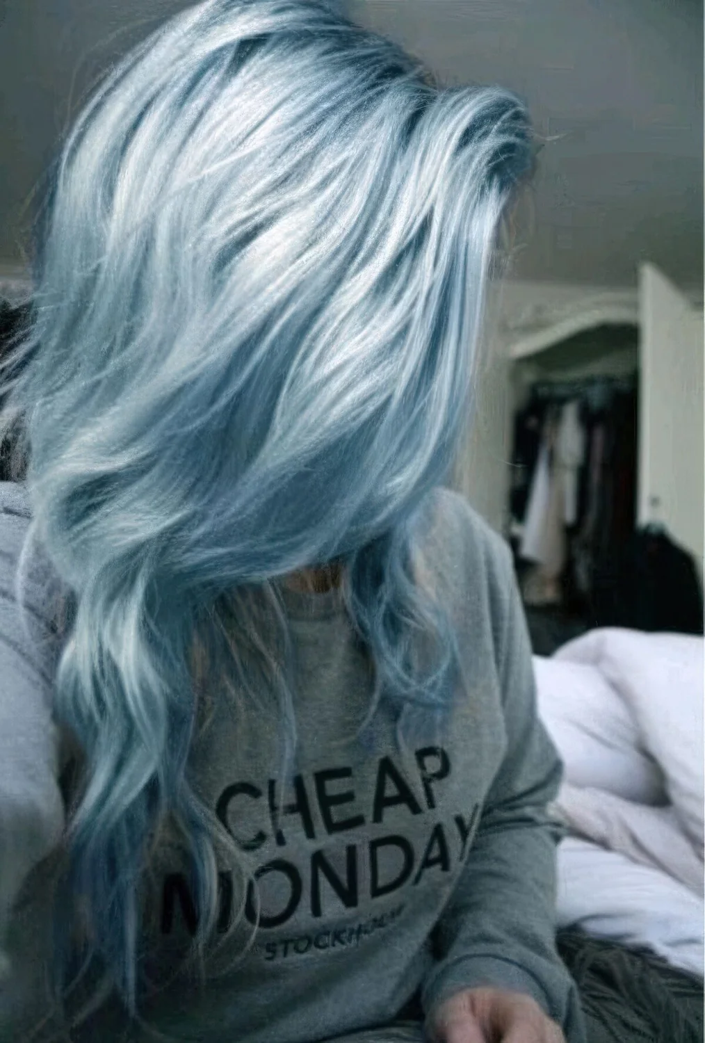 Long pastel blue hair with waves and much volume.