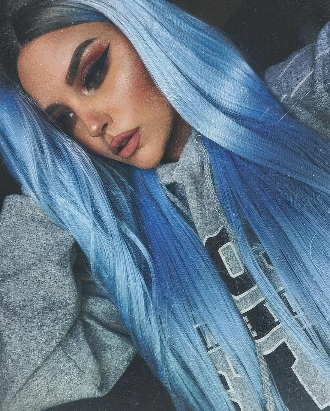 Pastel blue long hair with a greyish root.