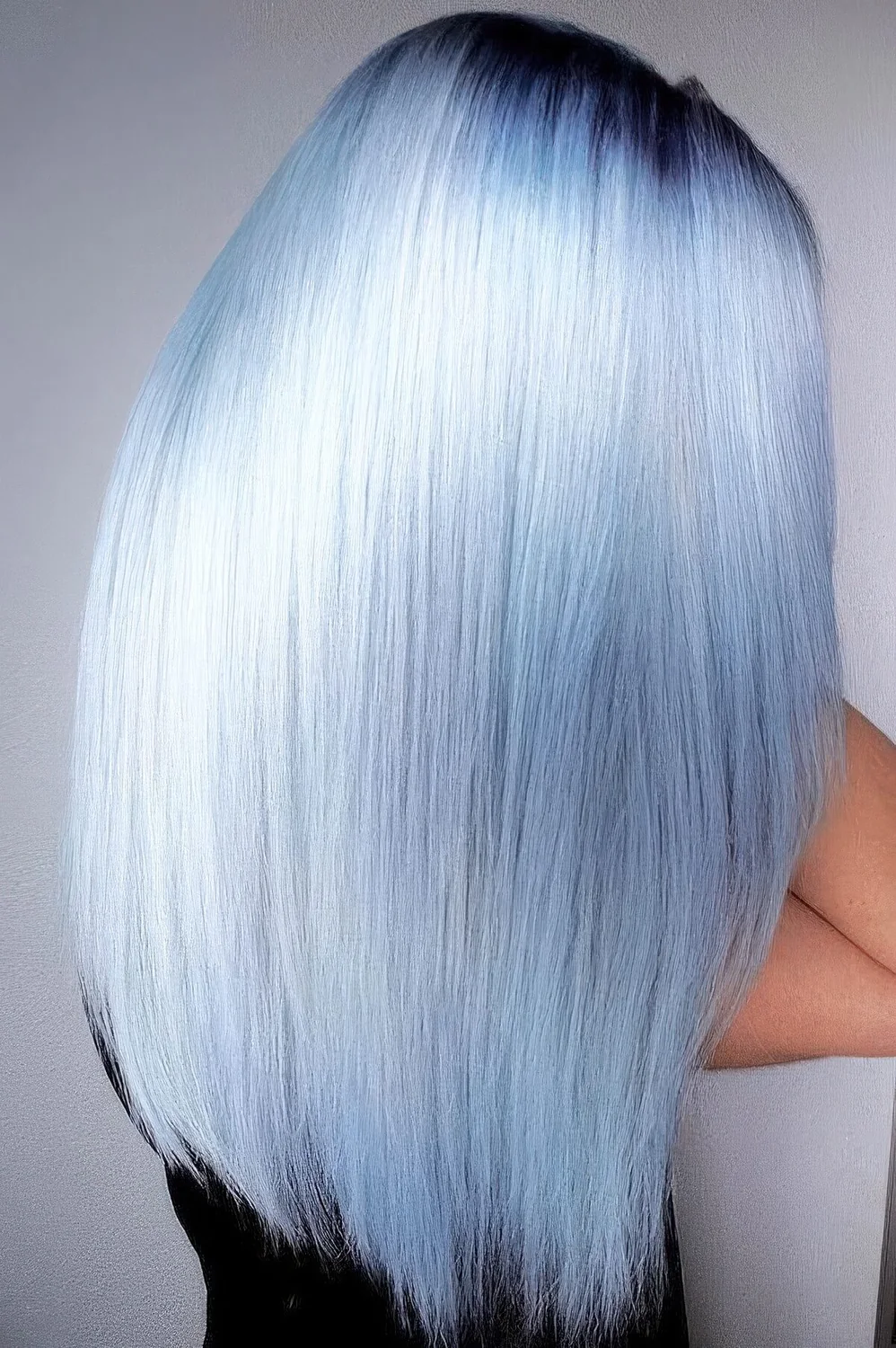 Silver and pastel blue hair with a gradient effect and a darker root.