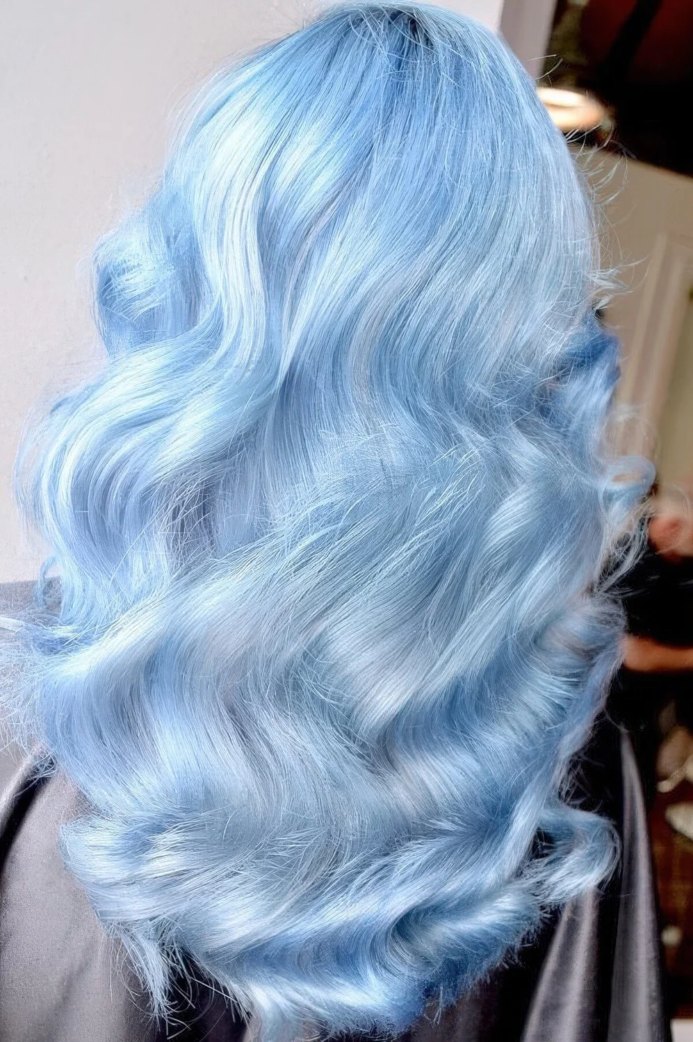 Jaw dropping pastel blue hair with natural waves.