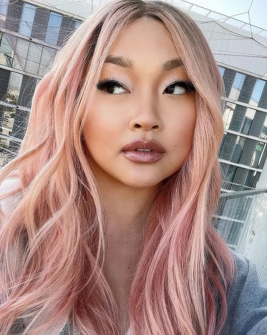 Long and textural peachy rose hair with a bit of vases and center part.