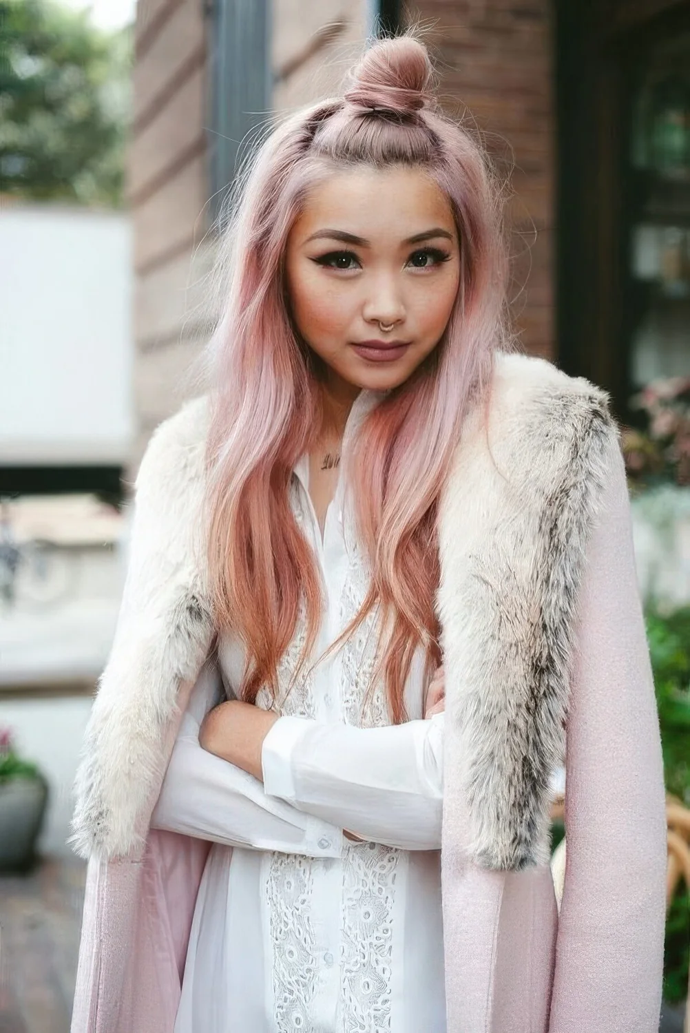 Long and wavy peachy rose gold hair with a bit of darker locks on the ends for creating an ombre effect.