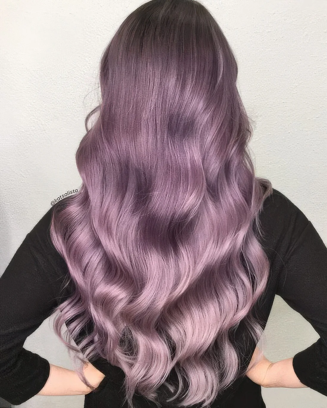 Long lavender hair with waves and volume.