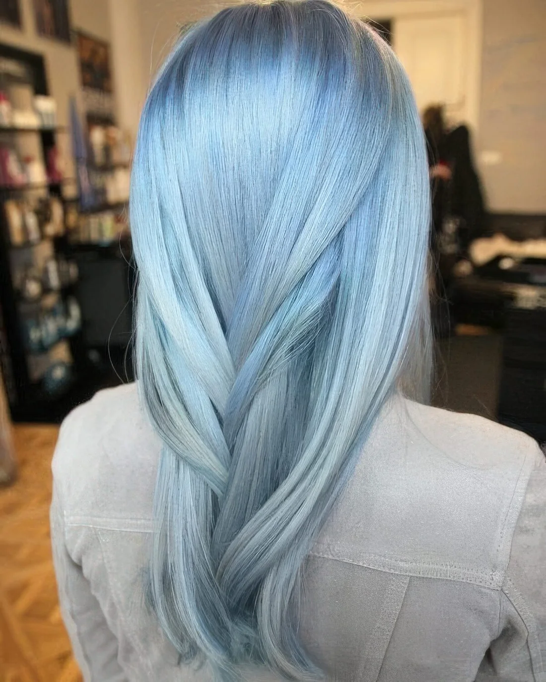 Long layered hair with a soft pastel blue shade and touches of aqua.