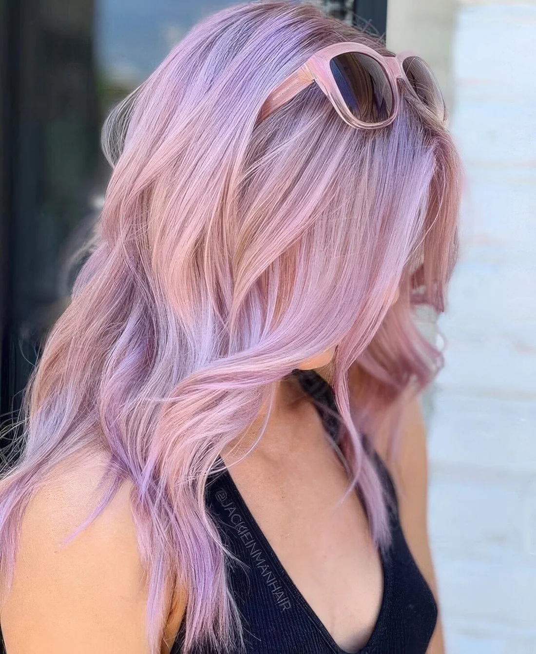 Long mauve hair with silver balayage, with shaggy layers and some waves.