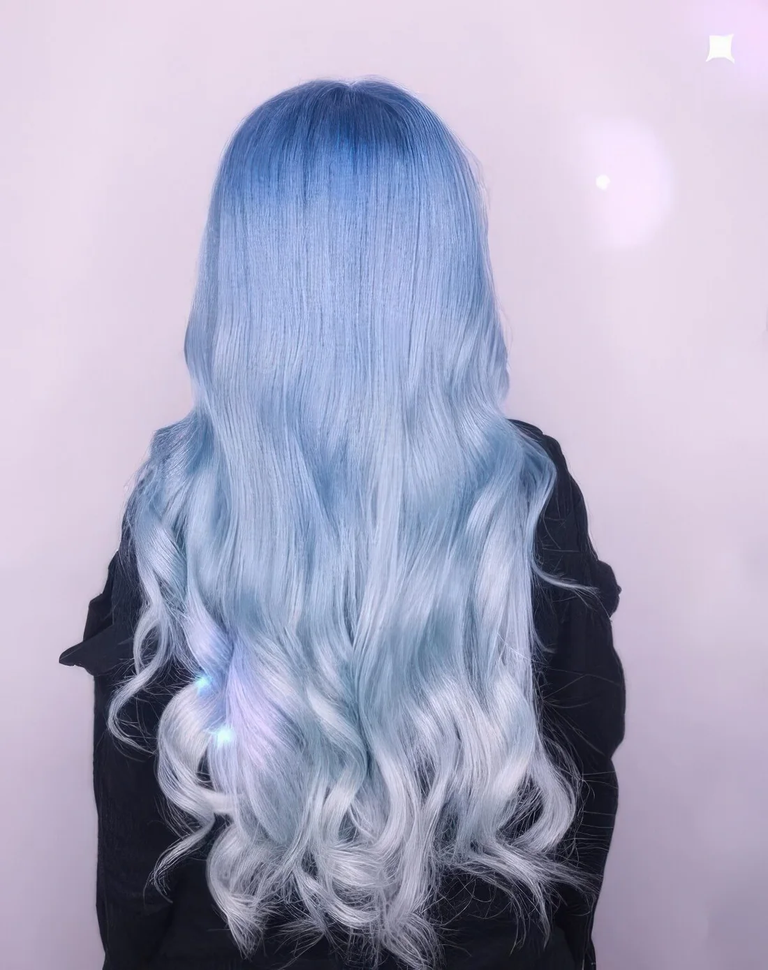 Long pastel blue to silver ombre hair with waves.