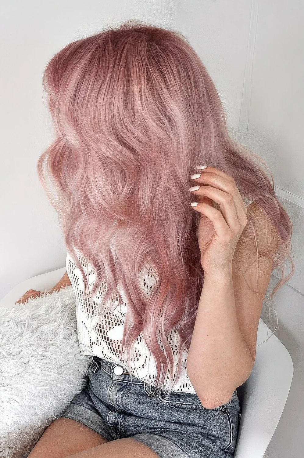 Long pastel pink hair with a lot of volume and texture.