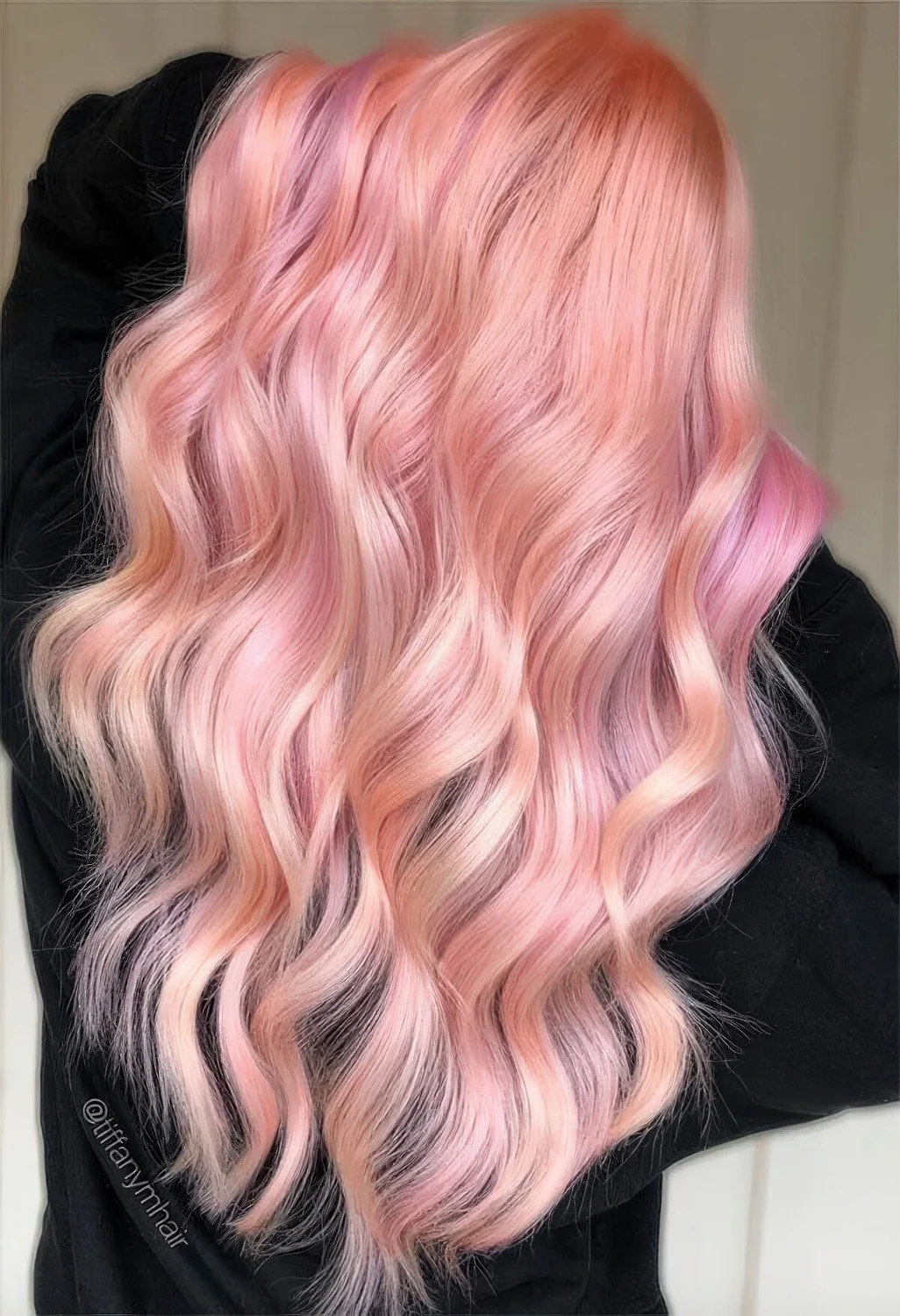 Photo showing long peachy pink hair, with the hairstyle clearly visible.