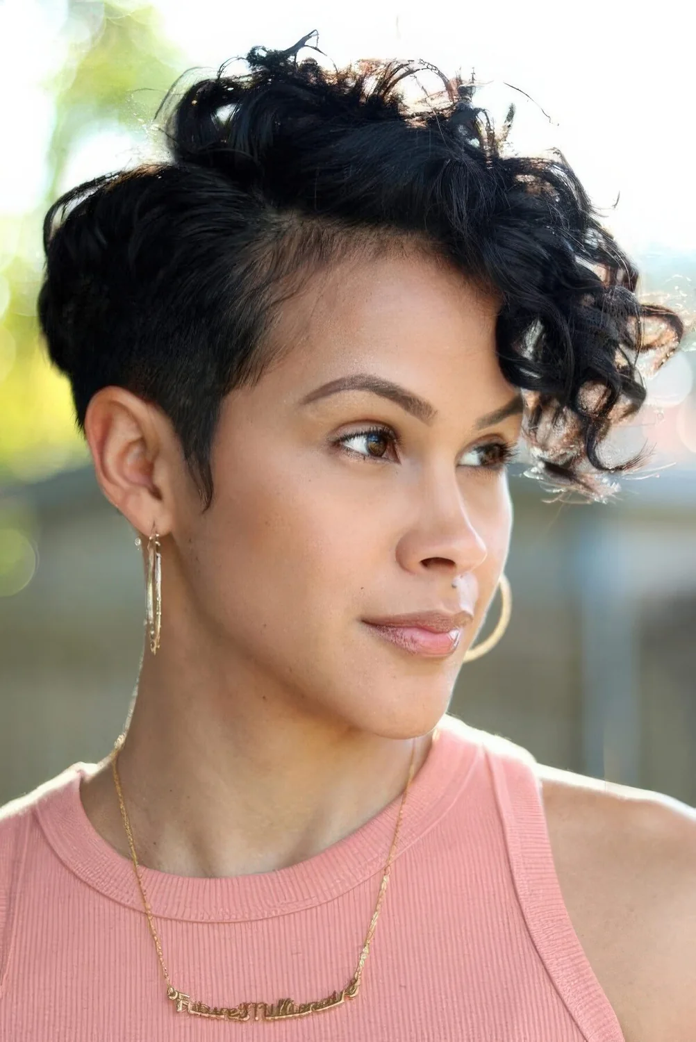 Photo showing black long curly pixie cut, with the hairstyle clearly visible.