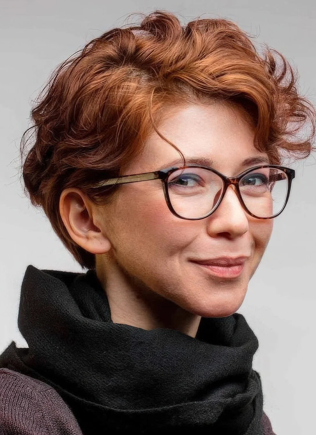 Ginger wavy pixie with short side bangs.