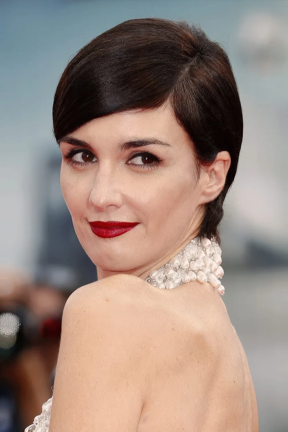 Slicked down long dark brown pixie.