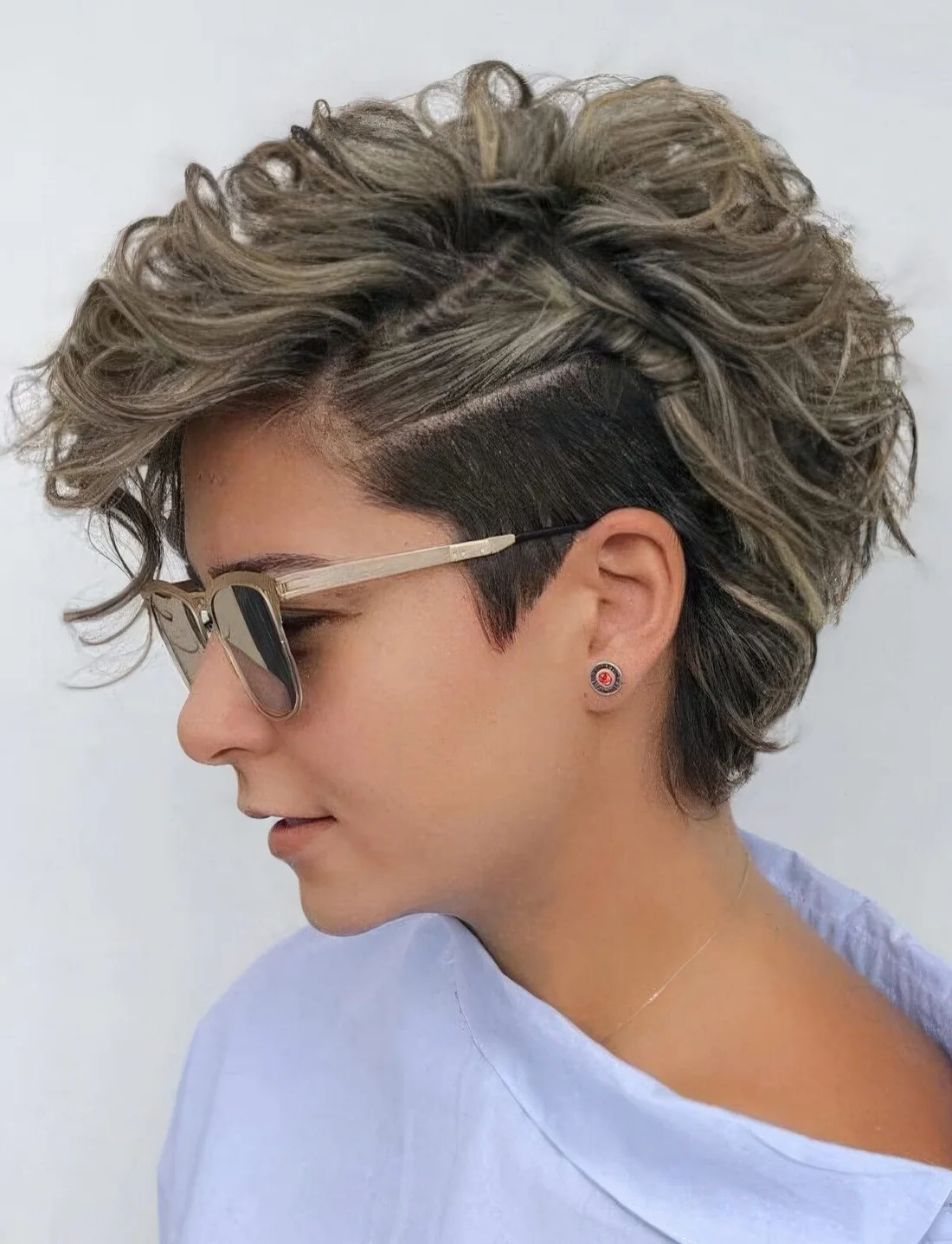 Asymmetrical messy wavy long pixie with a longer length to let more waves into your life, wave the top, setting it to one side with a good texturizing product.