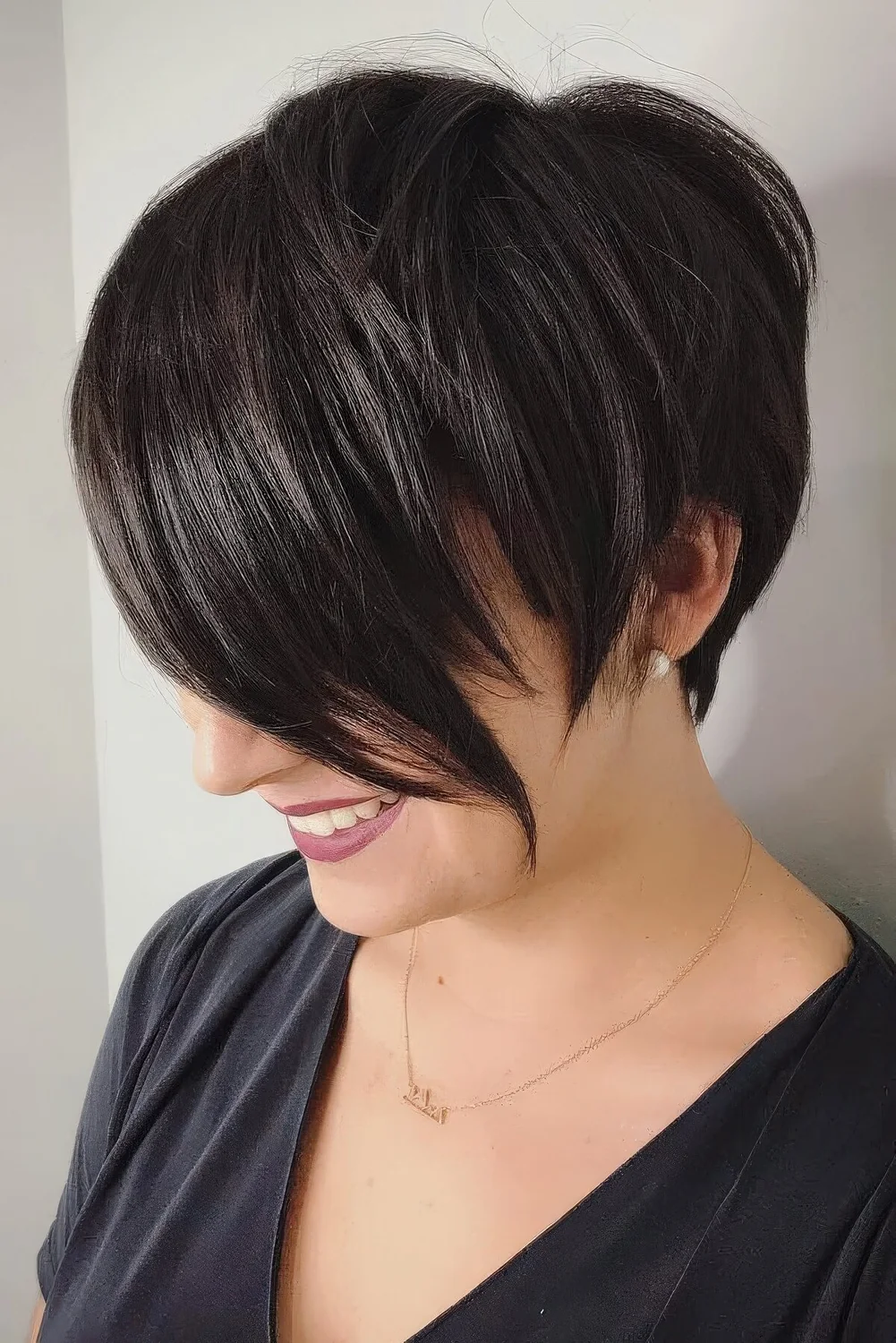 Asymmetrical pixie cut with long bangs.