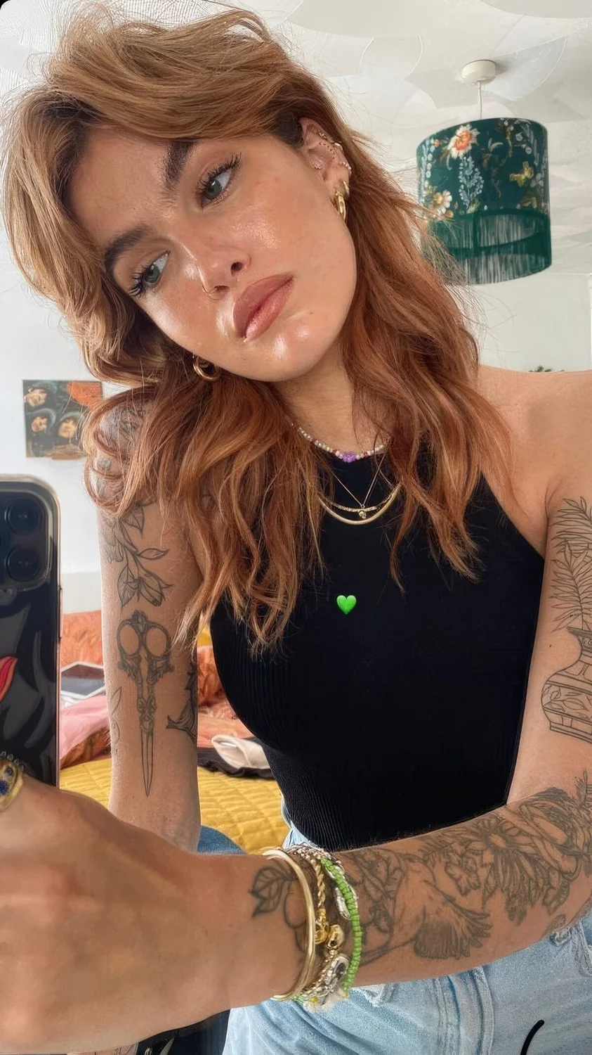 Ginger long wolf cut with voluminous curtain bangs and waves down.