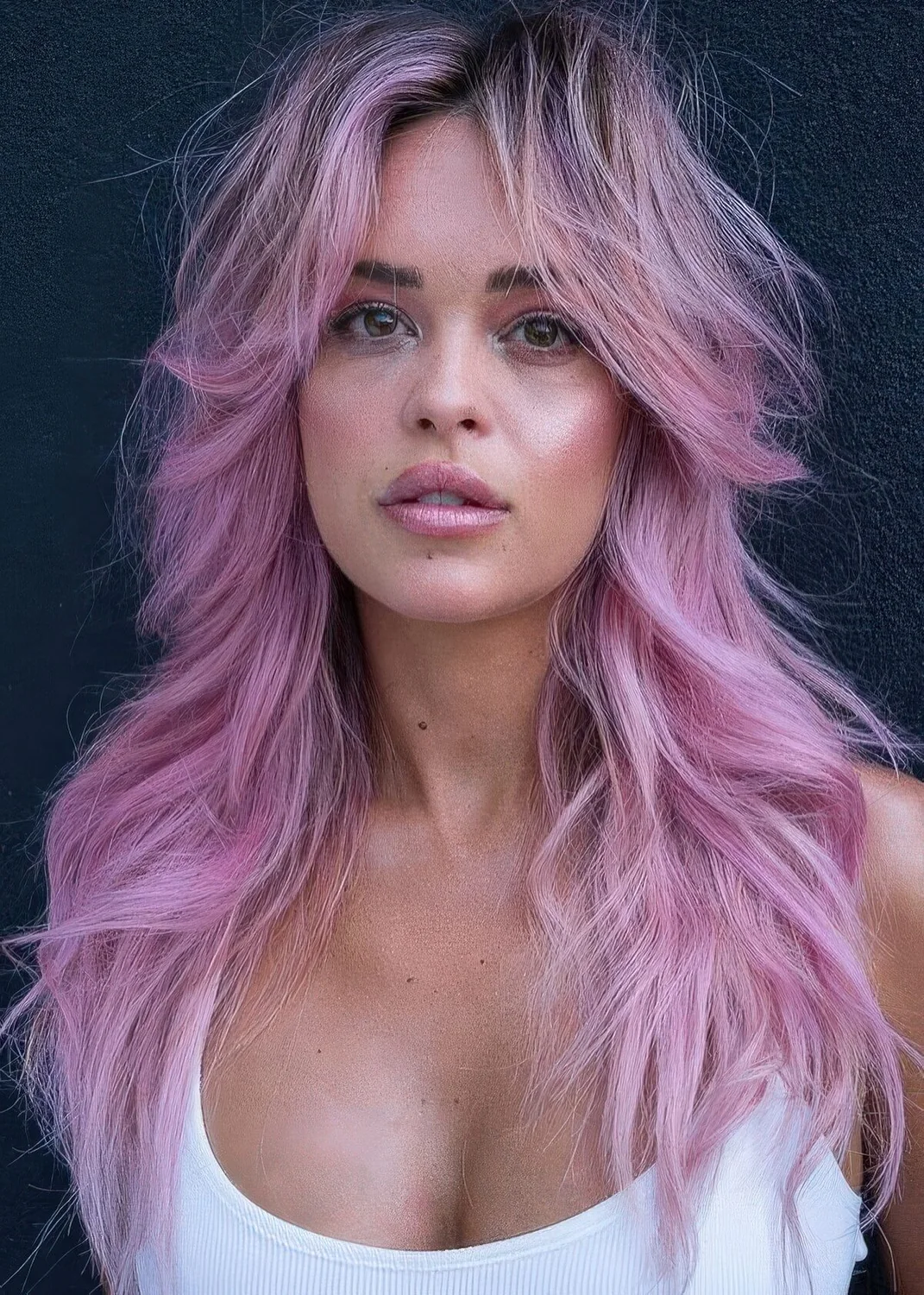 Pink long wolf haircut with curtain bangs and waves down.