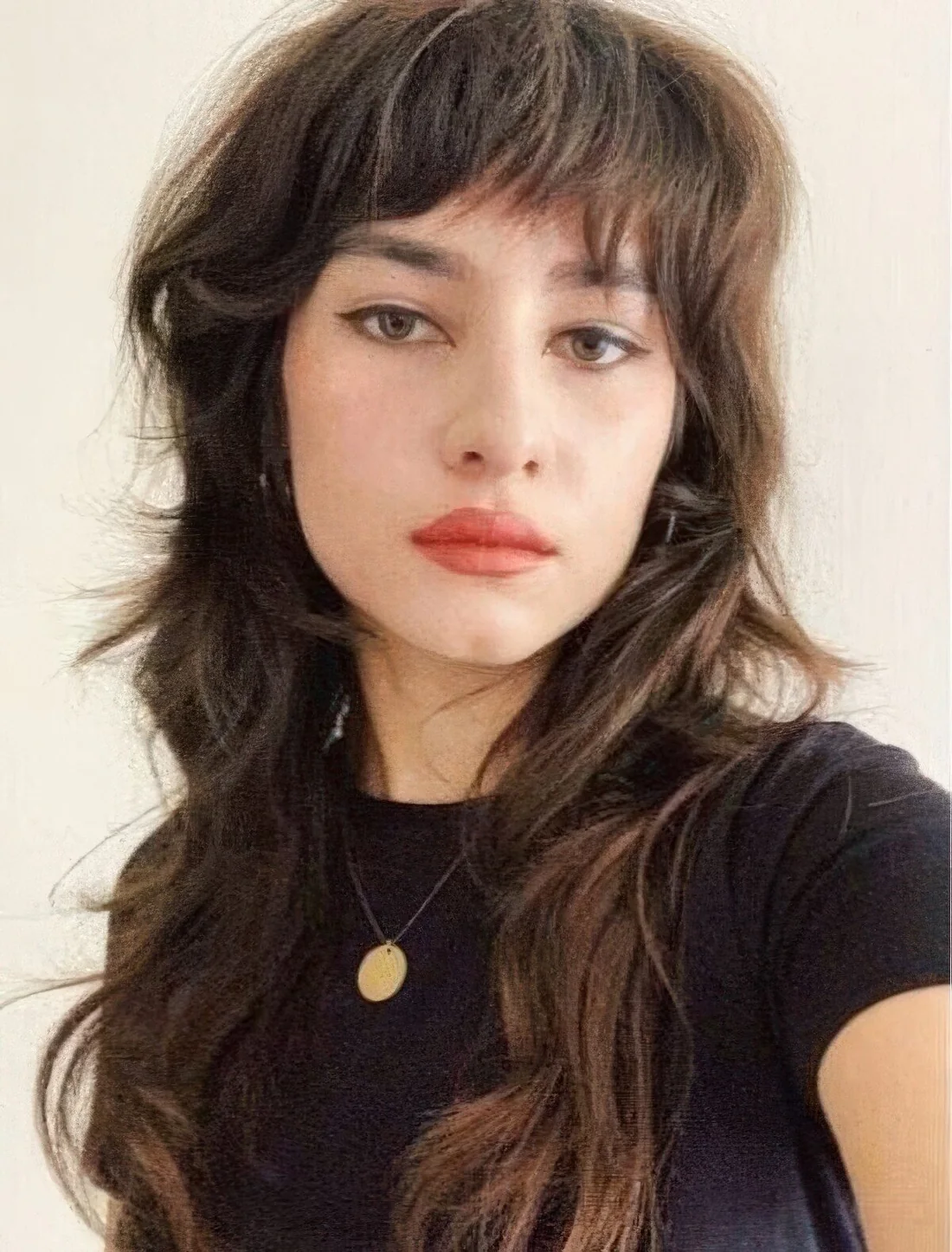 Wolf cut with textured and messy bangs and long tiers.
