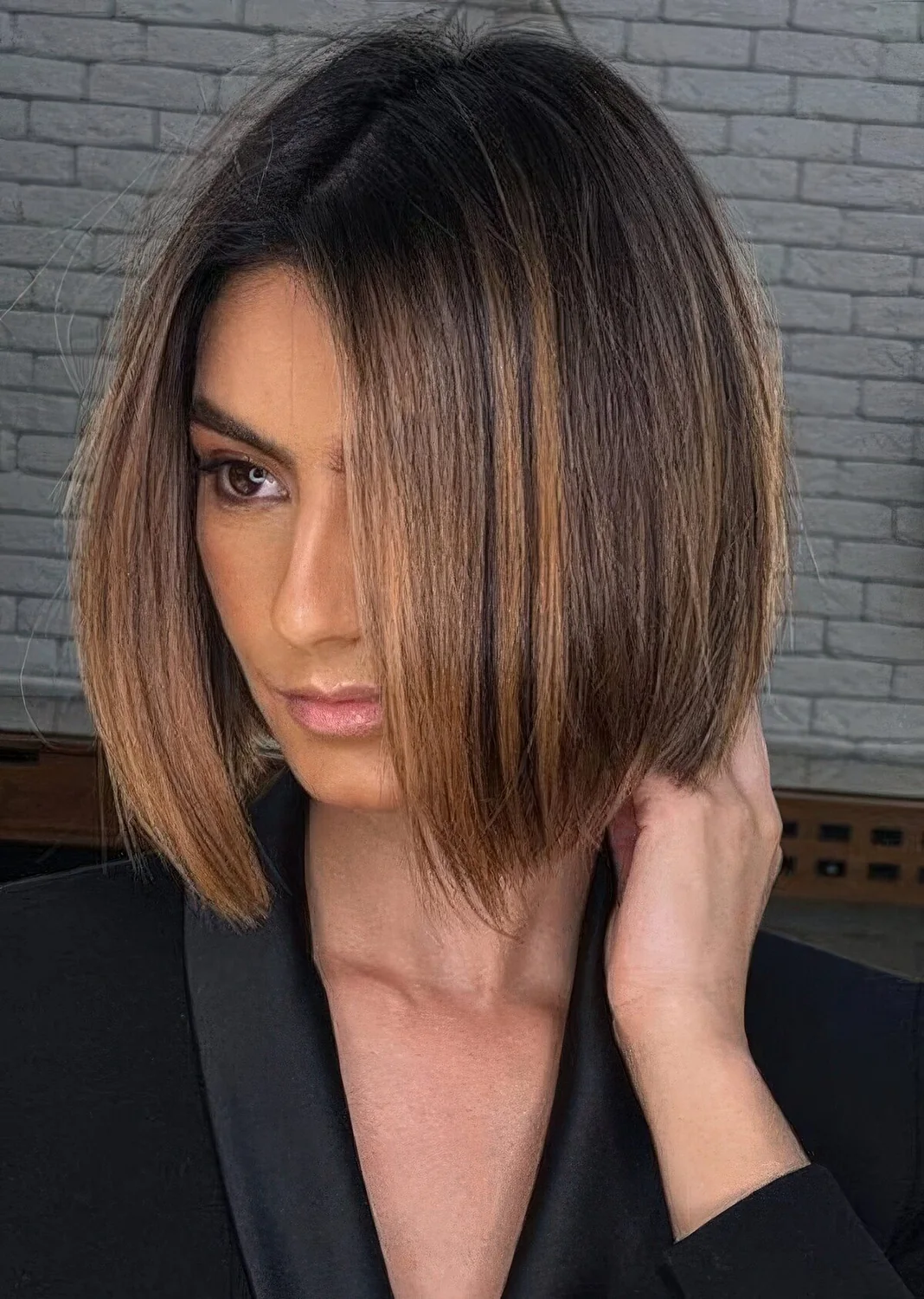 Dark brown bob with a darker root and caramel balayage.