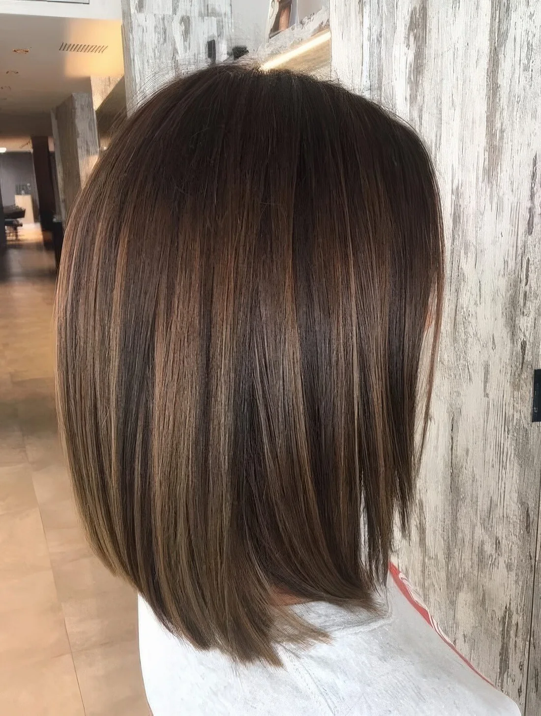 Black hair with lovely caramel and brunette balayage and babylights for maximal visual dimension and volume.