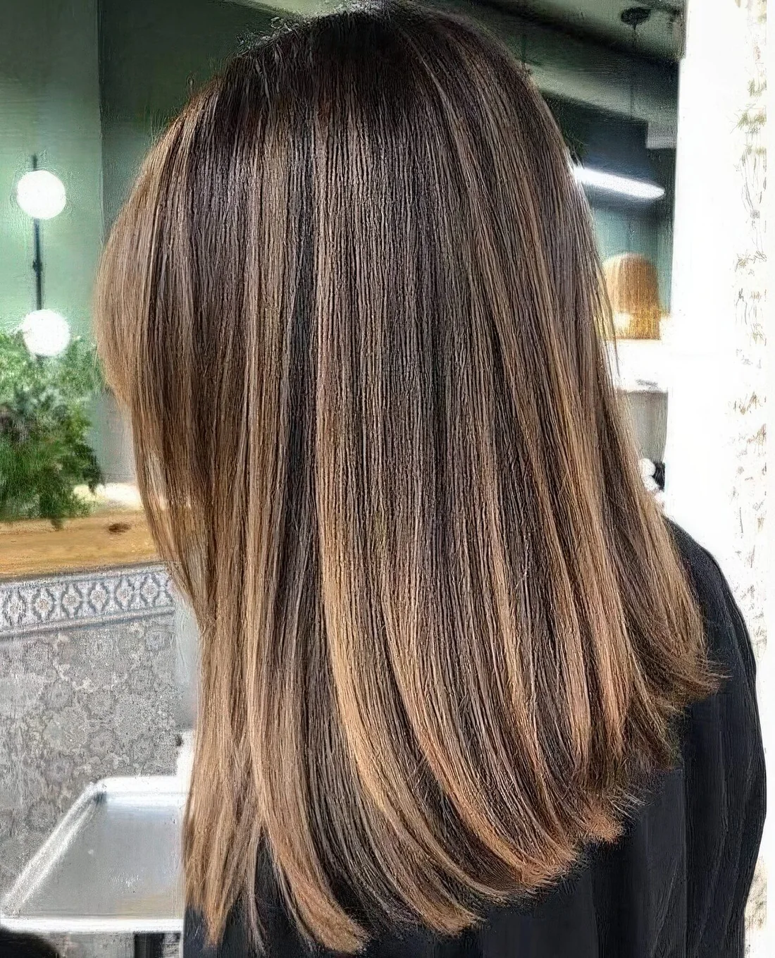 Dark brown hair with caramel balayage and some babylights for a beautiful and contrasting look.