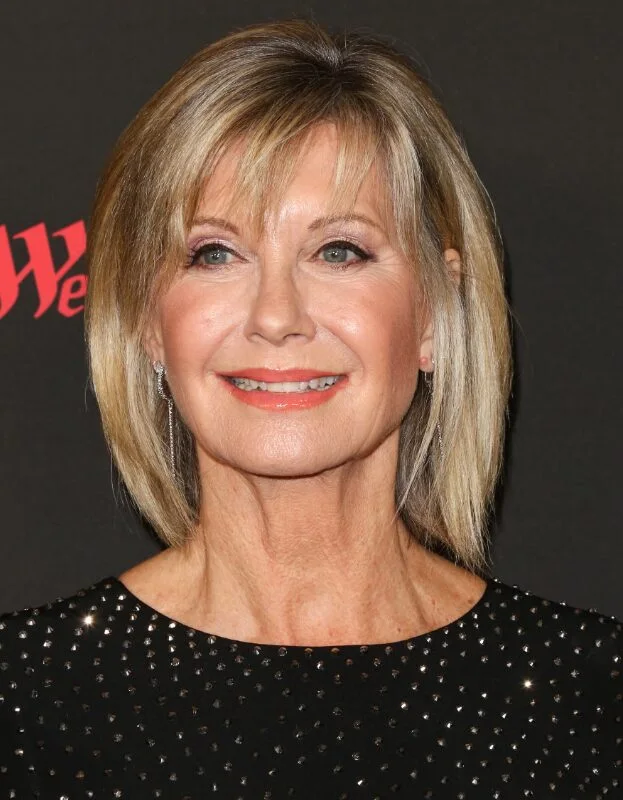 shoulder straight honey lob with wispy fringe shown as a low maintenance haircuts for fine hair idea