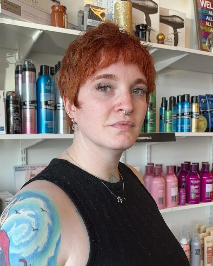 ear straight red pixie with micro fringe shown as a low maintenance haircuts for fine hair idea