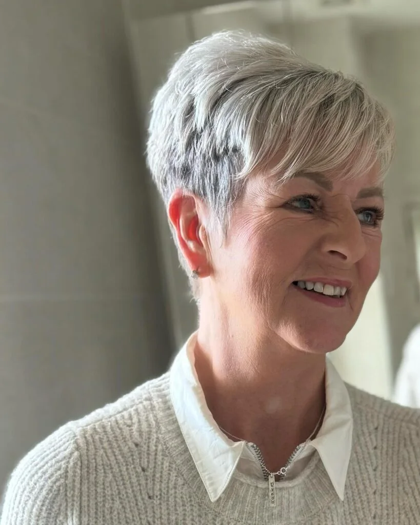 chin straight silver pixie with side swept fringe shown as a low maintenance hairstyles for 60 year old woman with fine hair idea