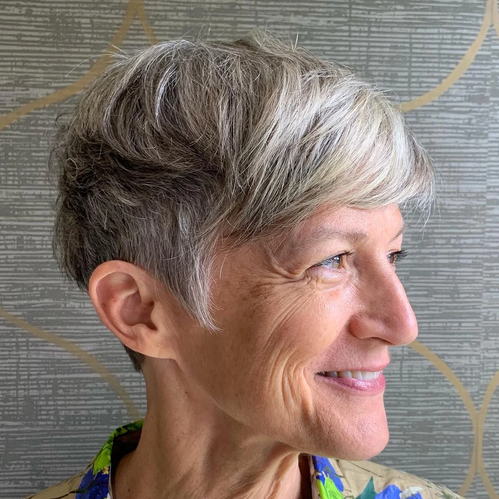 ear straight silver pixie with side swept fringe shown as a low maintenance hairstyles for 60 year old woman with fine hair idea, featuring ear outline