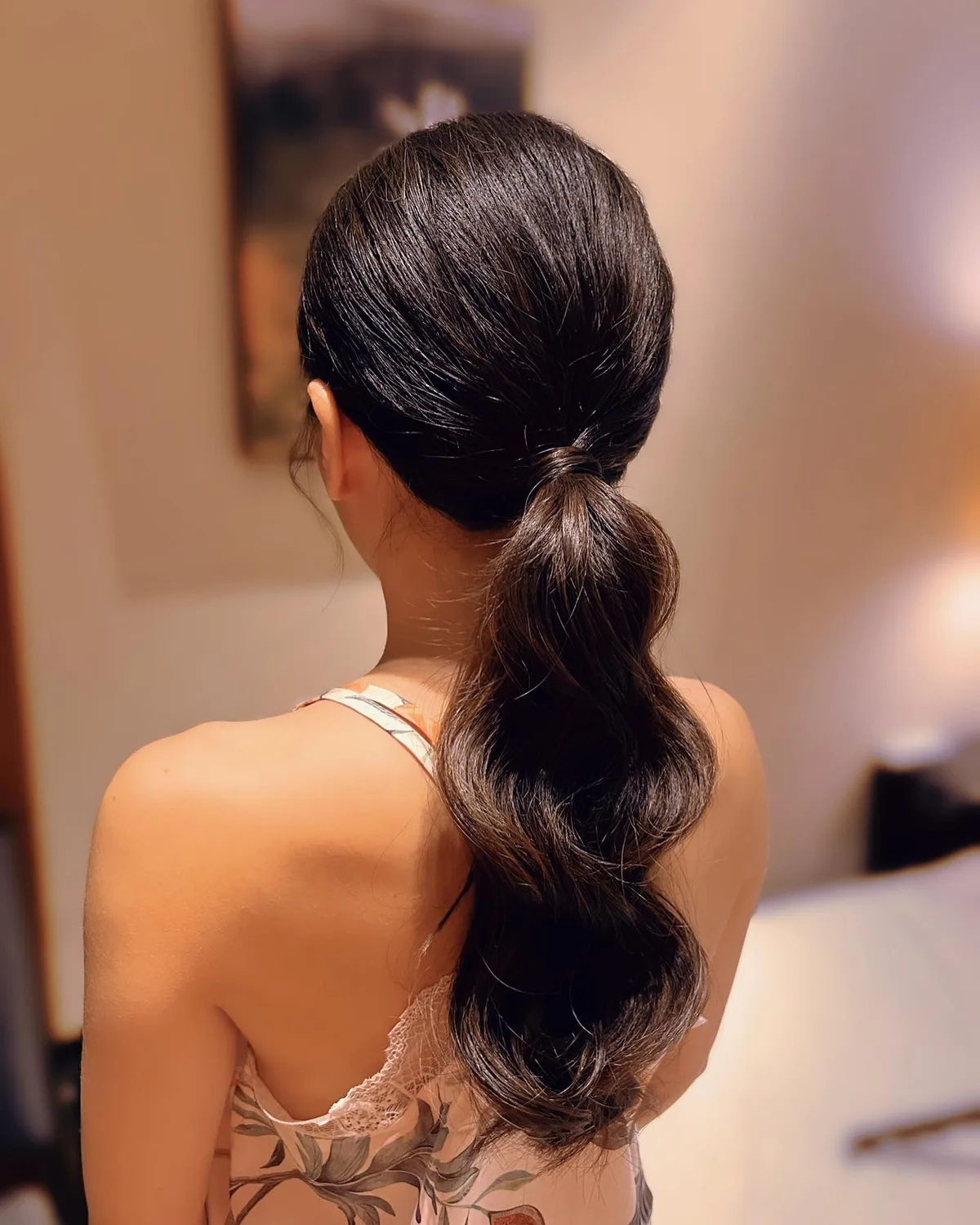 chest wavy brunette ponytail shown as a low ponytail hairstyles idea