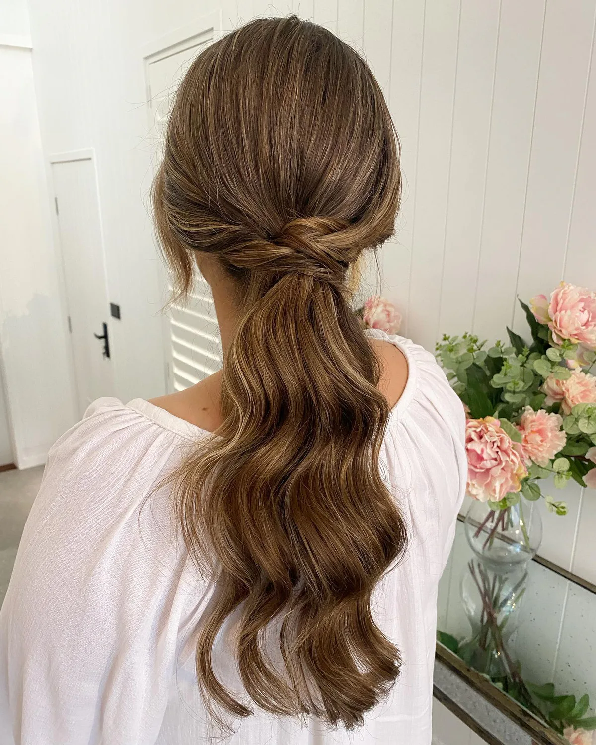 chest wavy brunette ponytail shown as a low ponytail hairstyles idea, featuring chest outline