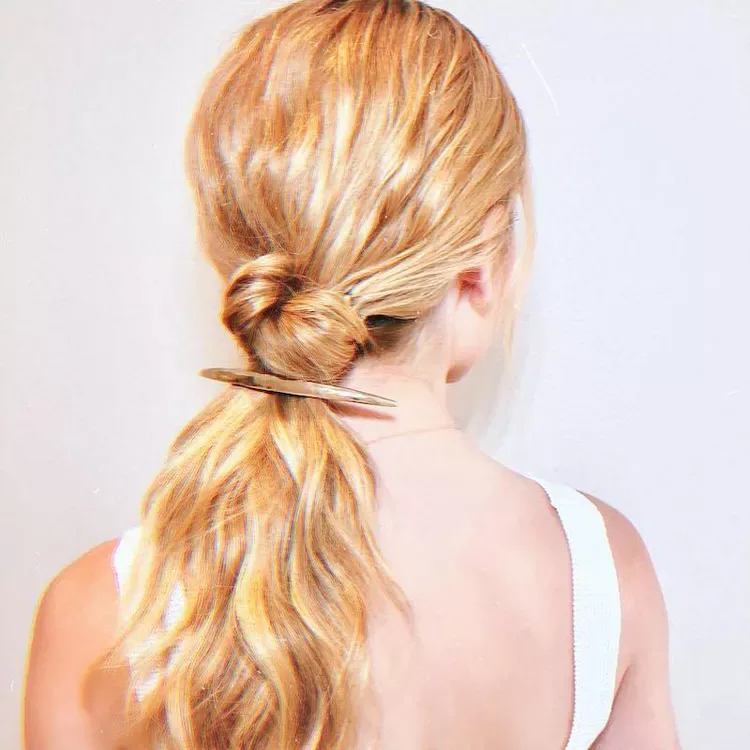 chest wavy blonde ponytail shown as a low ponytail hairstyles idea, featuring blonde color