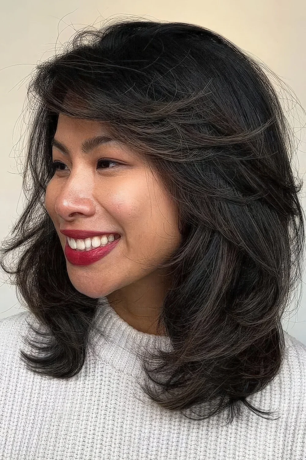 Black medium butterfly haircut with a lot of volume and texture.