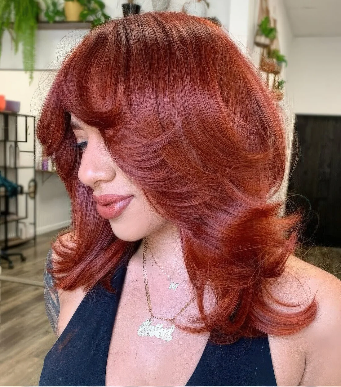 Red medium butterfly haircut with curled ends and a lot of volume.