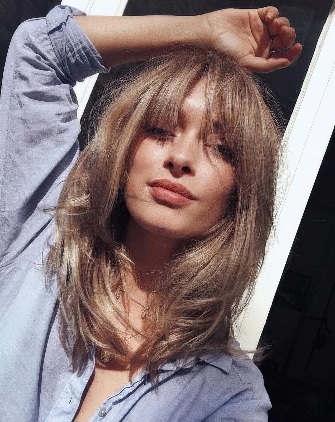 Bronde light bronde butterfly haircut with bottleneck bangs.