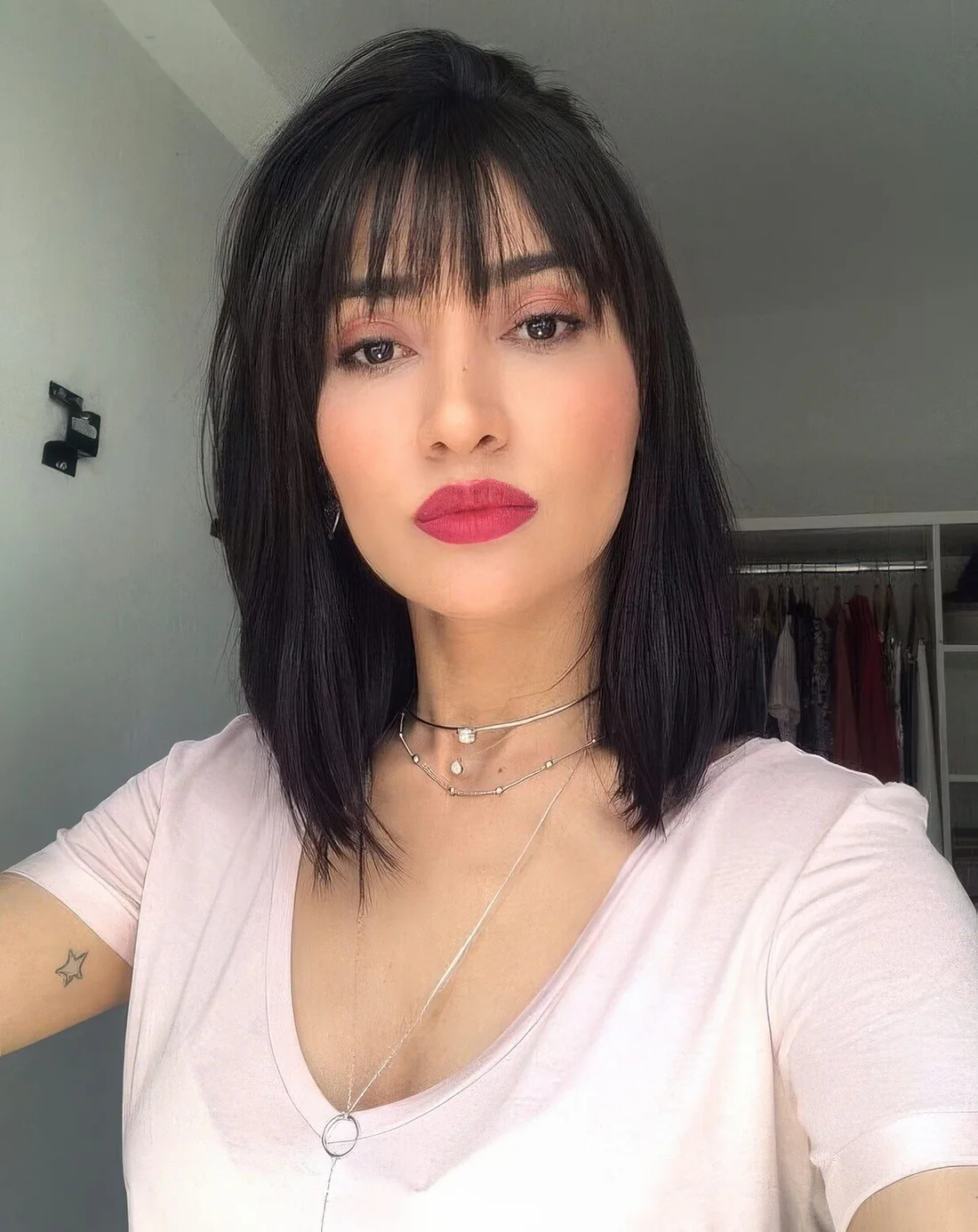 Black meidum length hair with delicate wispy bangs for a cuter and more girlish touch.