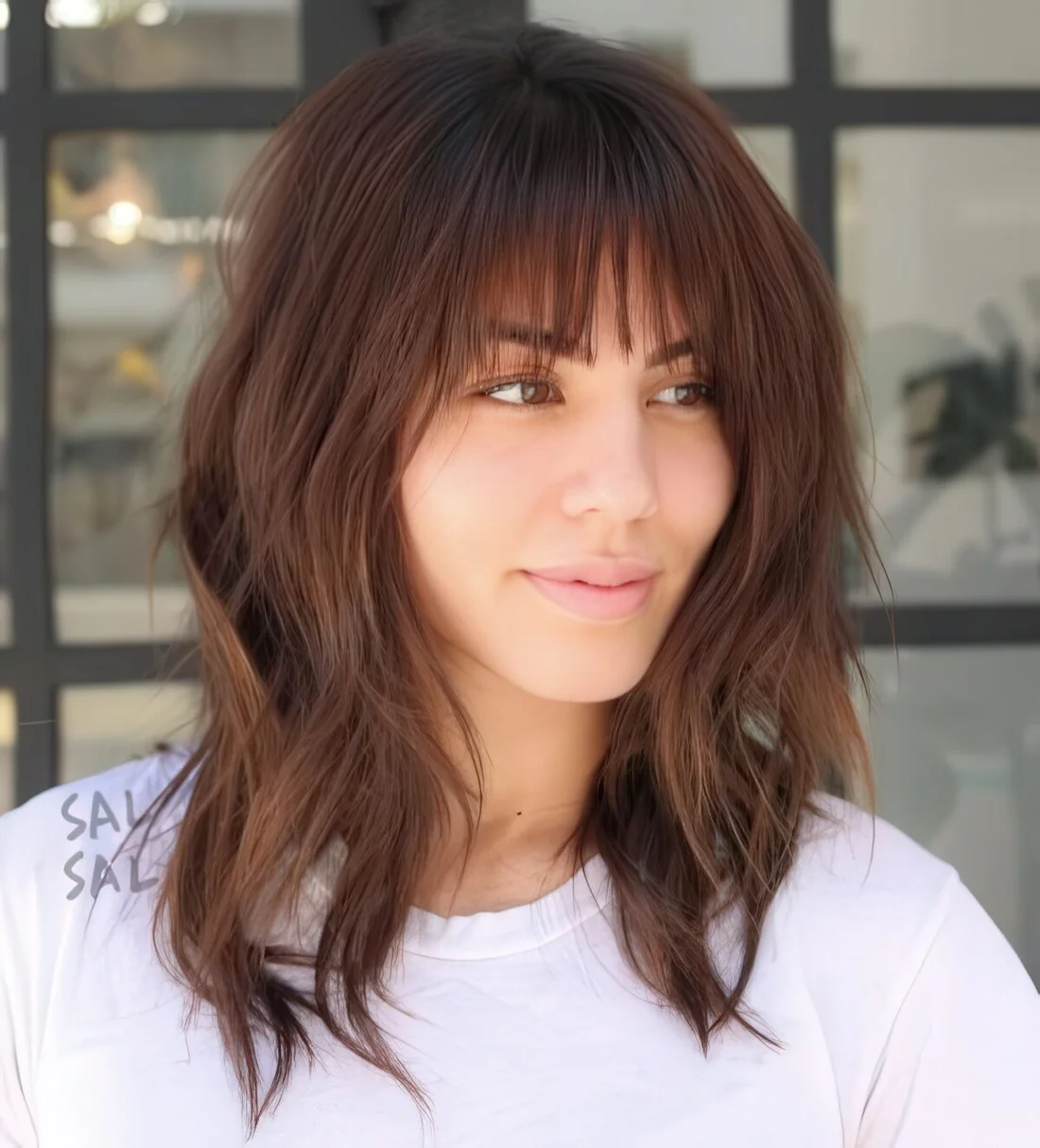 Layered long bob with a fringe and a bit of grunge for a bold look.