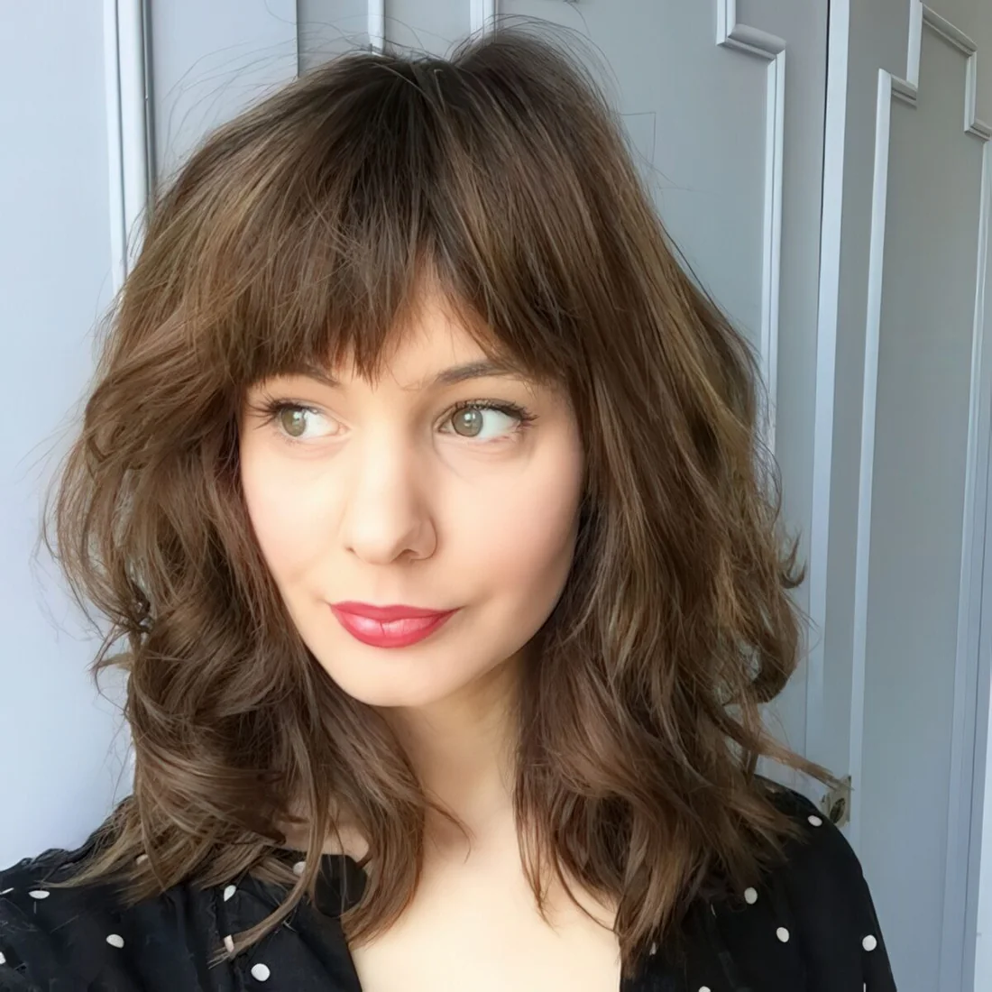 Medium-length haircut with a straight bang.