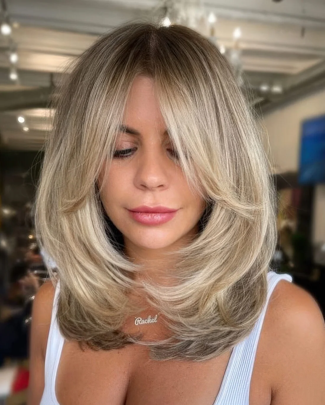 Photo showing blonde butterfly haircut, with the hairstyle clearly visible.