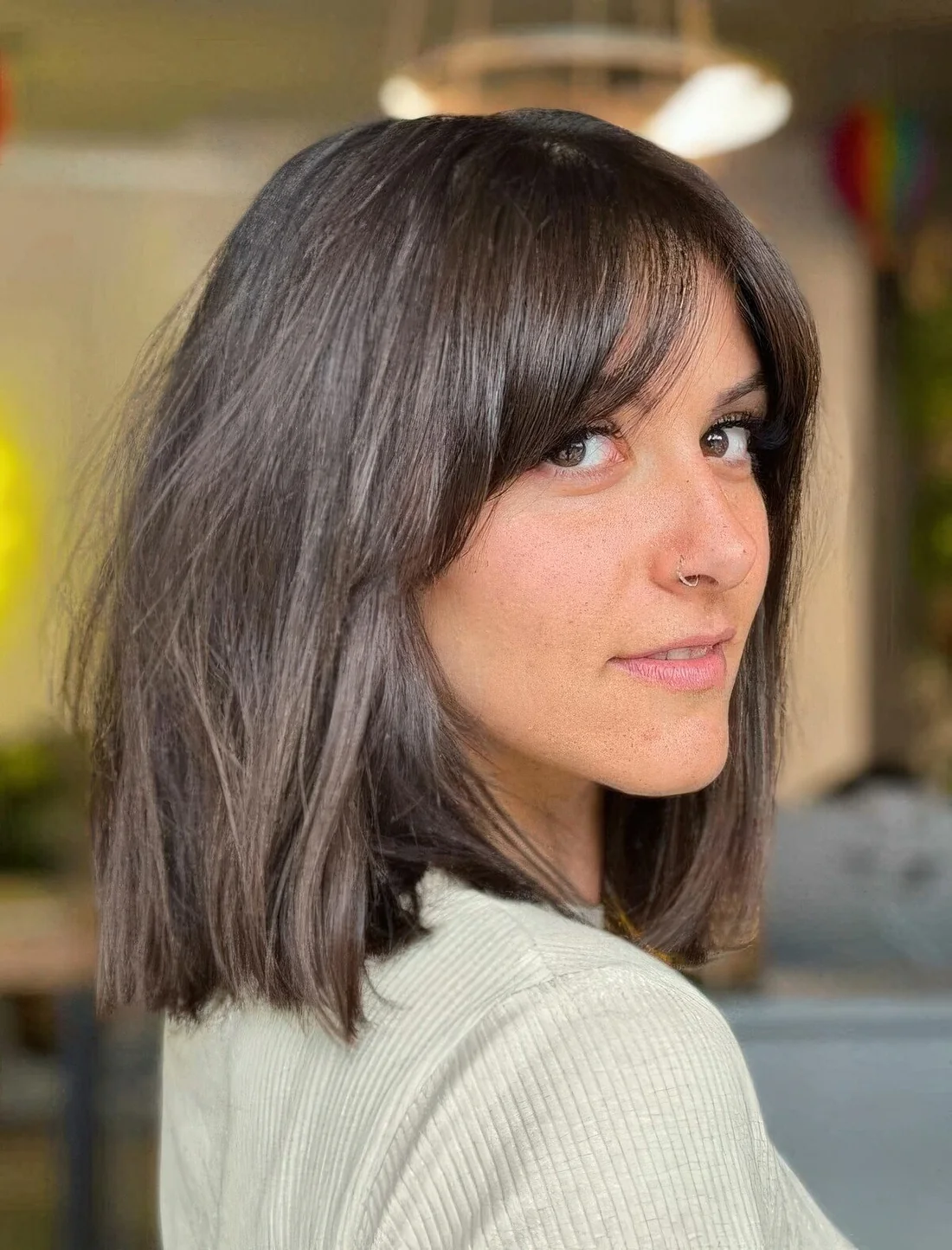Chic brown long bob with curtain bangs.