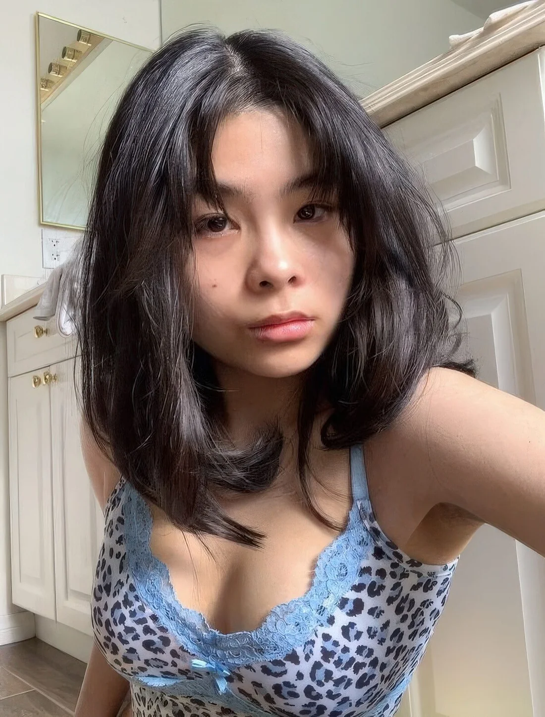 Medium butterfly haircut with short curtain bangs and a lot of volume.