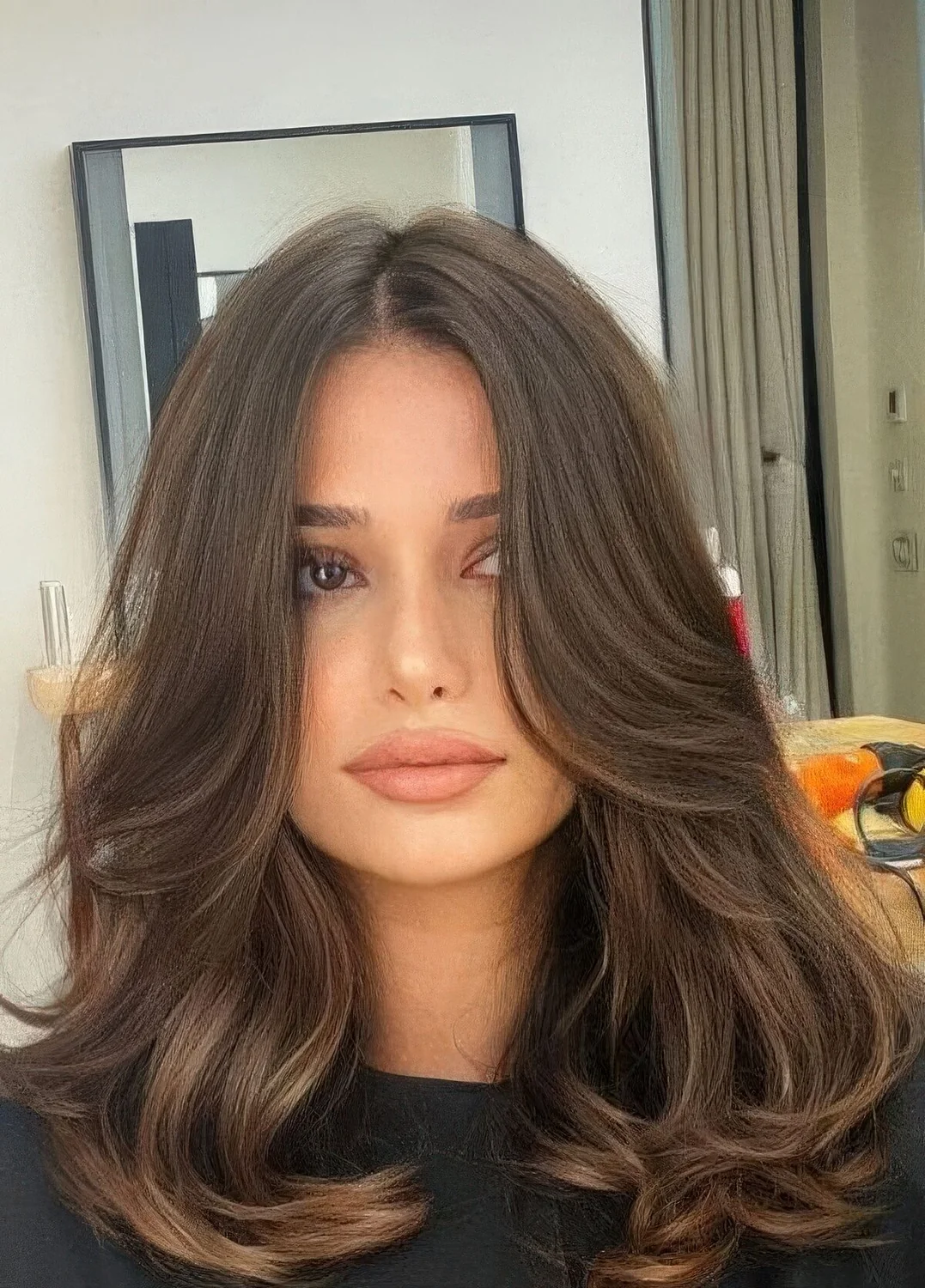 Butterfly haircut with curtain bangs, waves and a lovely brunette shade.