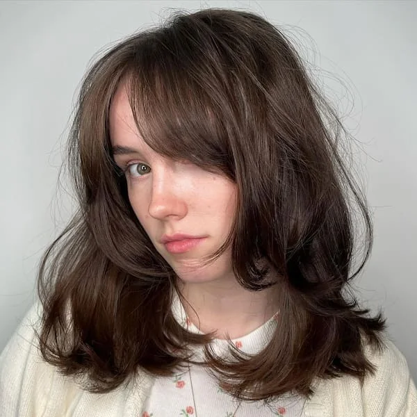 shoulder wavy brunette shag with curtain fringe shown as a medium length haircut ideas for thin fine hair idea